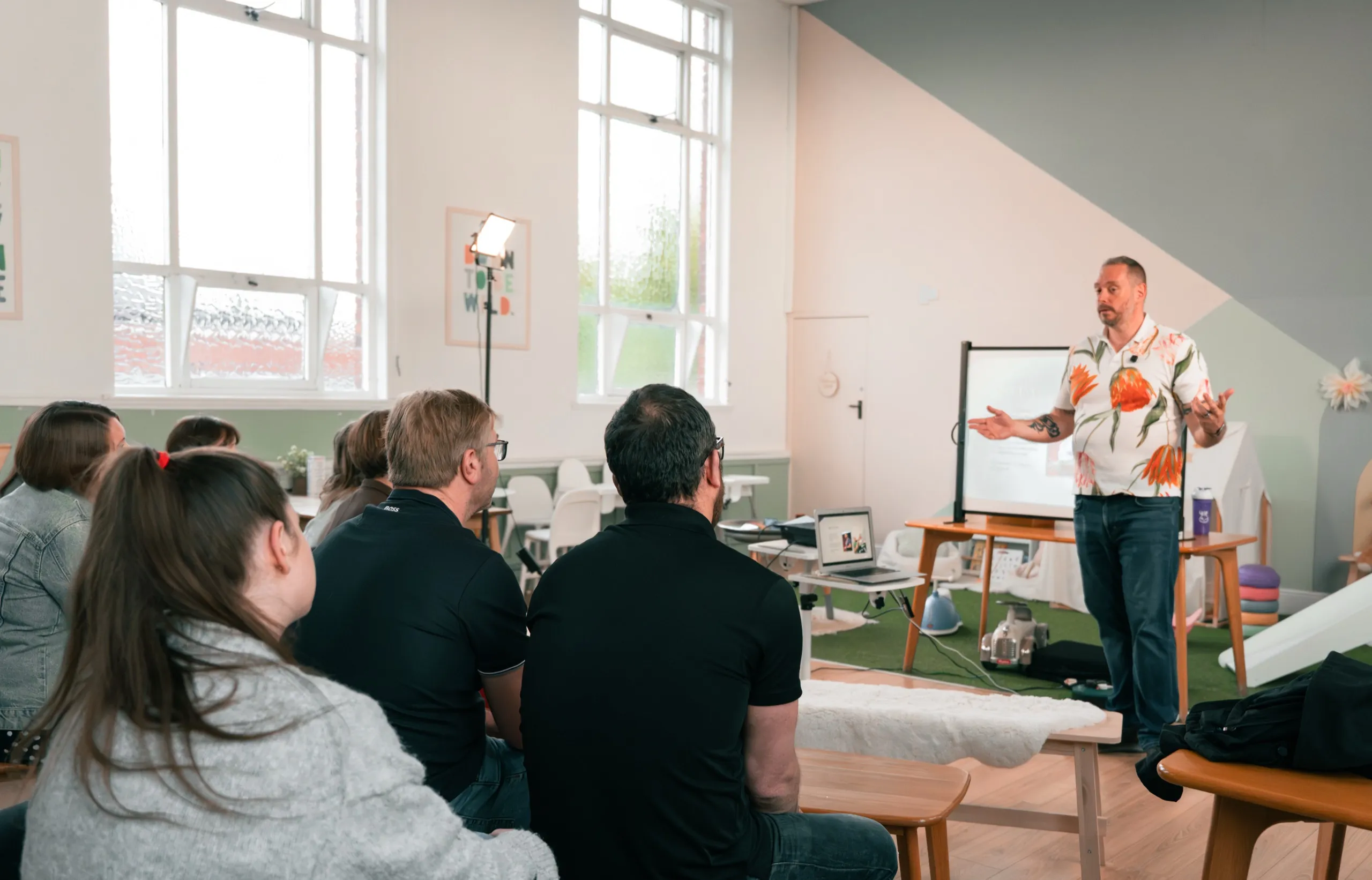 Dave Cottrell delivering a mental health talk to a small group in a workshop setting